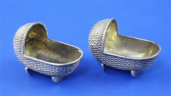 A pair of Victorian novelty silver salts, each modelled as a babys crib, by Edward H. Stockwell, 2.5 oz.